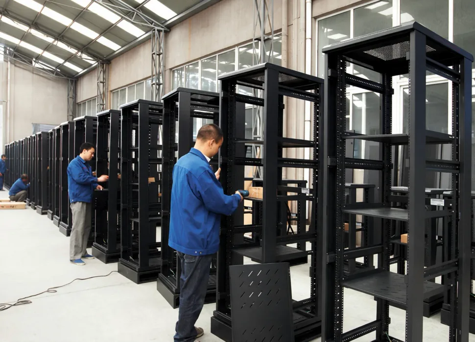 Grantec workers assembling rows of black server racks and network cabinets on the factory floor in Cixi, Ningbo